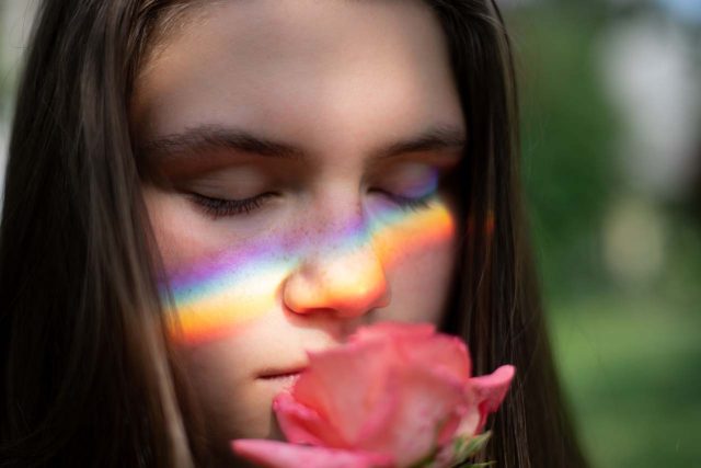 eye care, girl suffering vision loss, eyes closed, smelling rose in Tulsa, OK