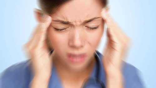 woman with vertigo and headache