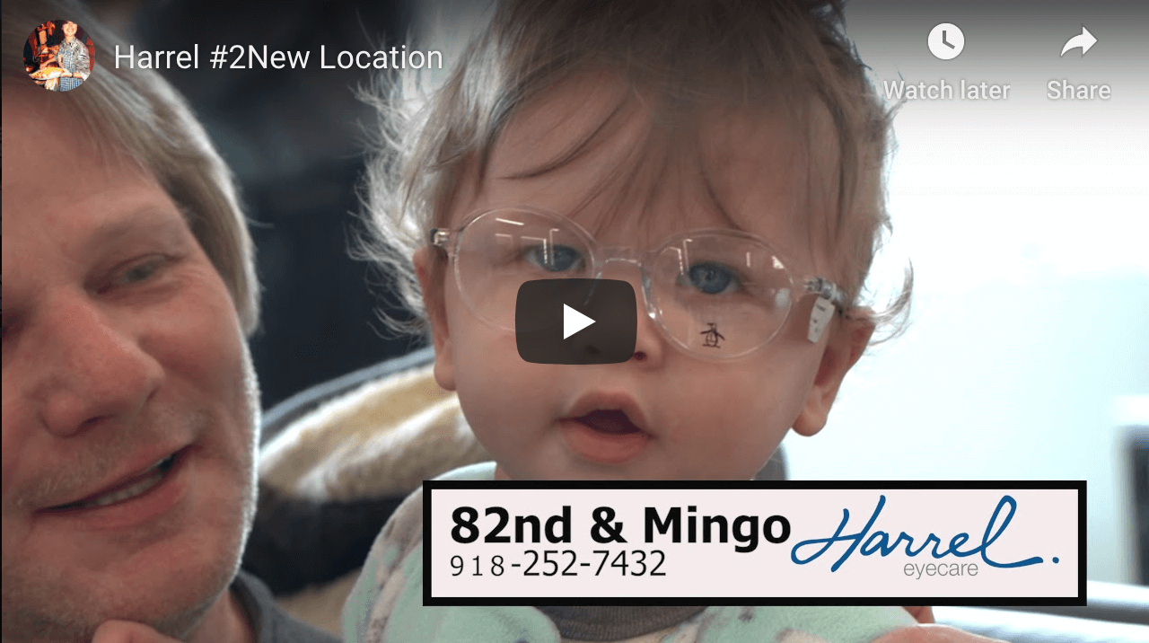 cute toddler trying on glasses after pediatric eye exam