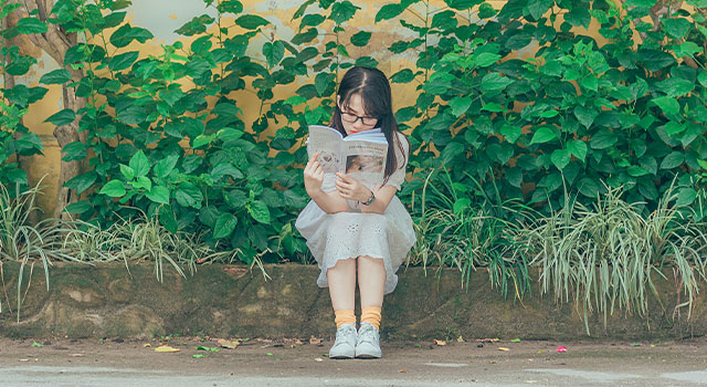 young child reading a book 640×350