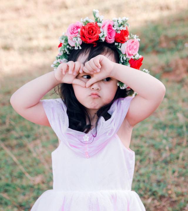 girl covering her face floweers